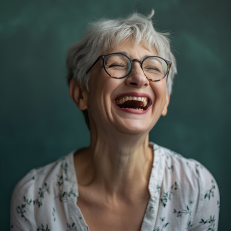 an older woman with glasses and a white shirt laughingの素材
