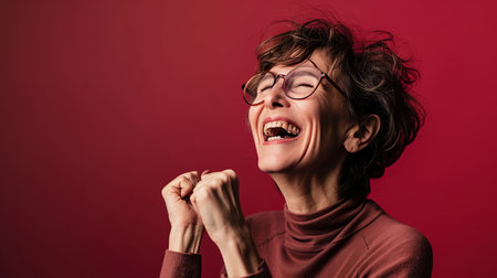 an older woman with glasses and a red backgroundの素材