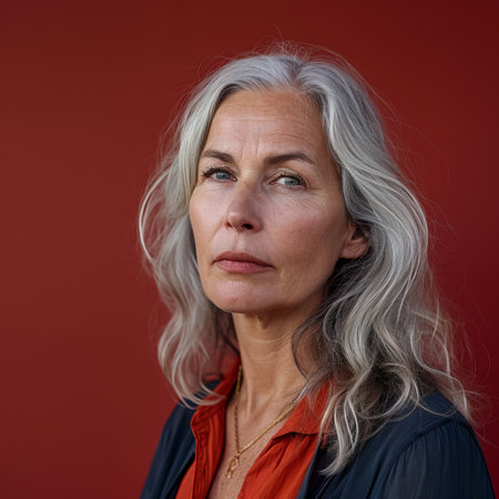 an older woman with gray hair against a red backgroundの素材