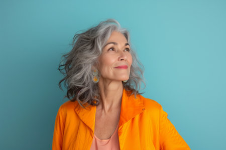 an older woman with gray hair wearing an orange jacketの素材