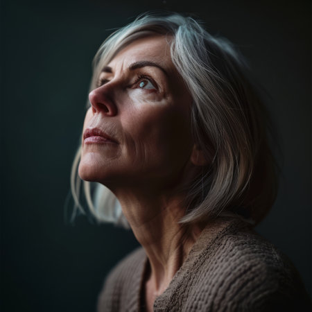 an older woman with gray hair looking upの素材