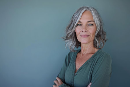 an older woman with gray hair posing for the cameraの素材