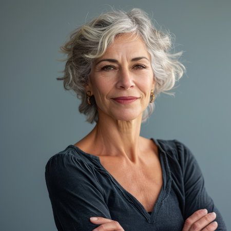 an older woman with gray hair standing with her arms crossedの素材
