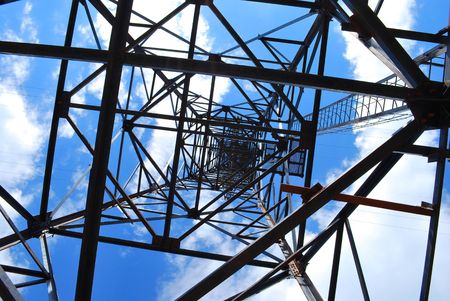 Abstract high-voltage tower on blue sky backgroundの写真素材