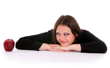 girl staring at the red apple isolated on whiteの写真素材