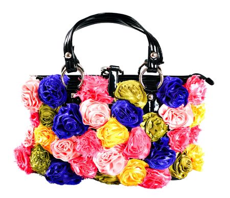 female bag with artificial flowers isolated on whiteの写真素材