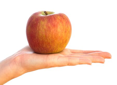 red apple on female palm isolated on whiteの写真素材