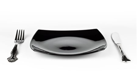 empty black dish knife and fork isolated on white