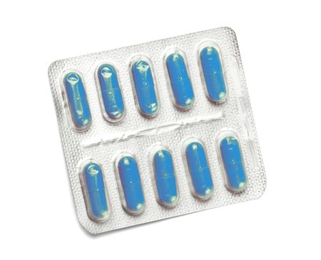 package of blue capsules isolated on whiteの写真素材