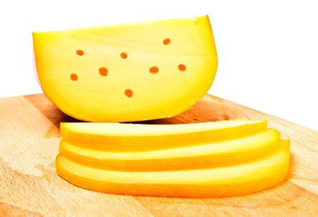 cheese slices on cutting board, white backgroundの写真素材