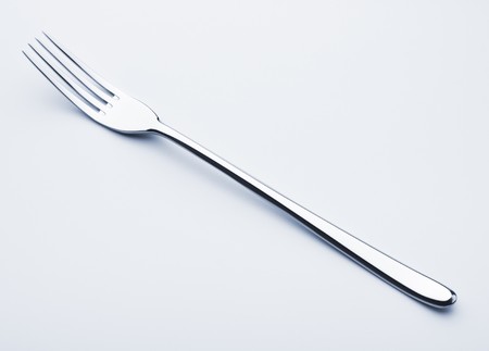 single fork on grey background
