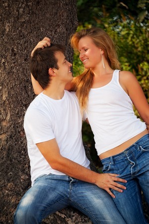smiling couple next pine treeの写真素材
