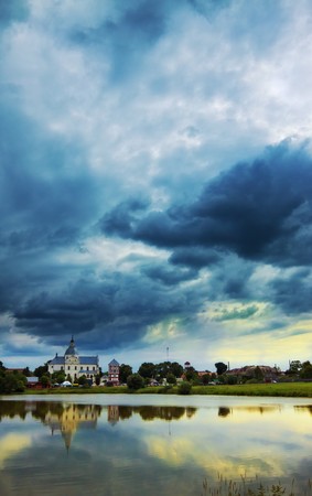 monastery on calm lake at eveningの写真素材