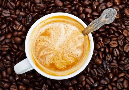 espresso cup in coffee beans, top viewの写真素材