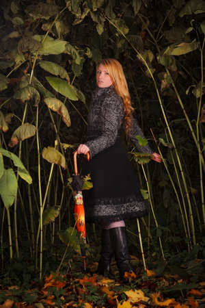beautiful girl running in enchanted forestの写真素材