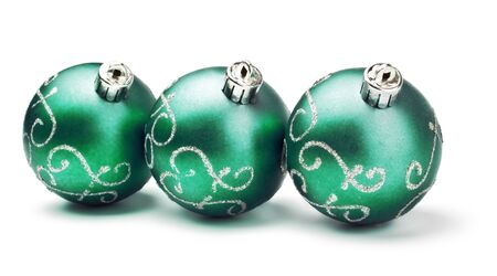 three green decoration balls isolated on whiteの写真素材