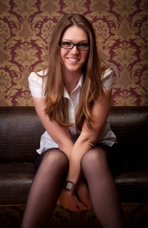 beautiful girl sitting on sofaの写真素材