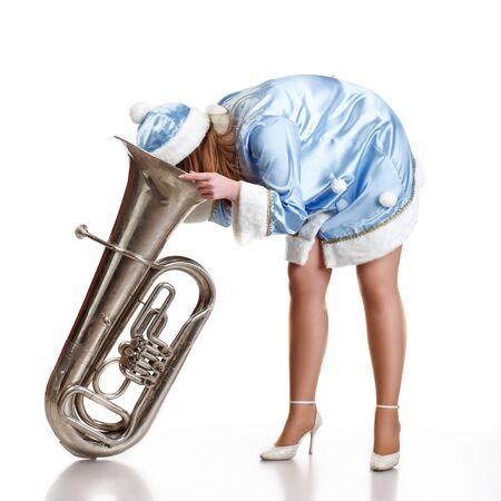  funny santa girl stuck head in big trumphetの写真素材