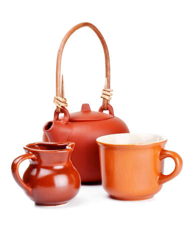 clay kettle, cup and jug isolated on whiteの写真素材
