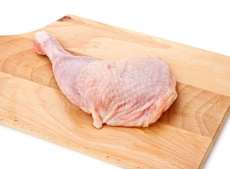 fresh chicken thigh laying on cutting boardの写真素材