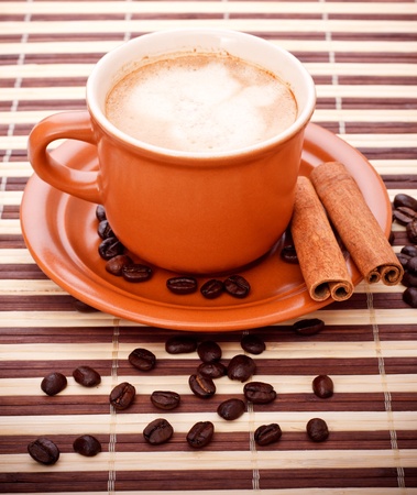 fresh coffee cup and beans on bamboo napkinの写真素材
