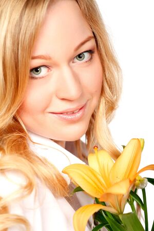 beautiful young woman with lily flower, close-up portraitの写真素材