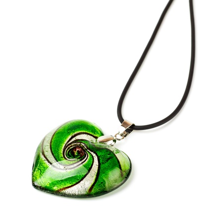 green heart-shaped pendant isolated on white backgroundの写真素材