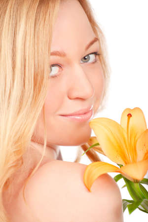 beautiful young woman with lily flower, close-up portraitの写真素材