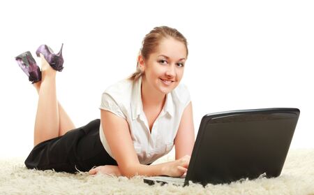 woman laying on floor with laptop computerの写真素材