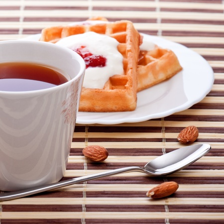 dessert with soft waffle, tea and raspberry jamの写真素材