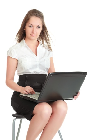 young businesswoman sitting on chair with laptop, isolated on whiteの写真素材