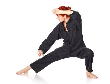 girl in black kimono exercise, isolated on whiteの写真素材