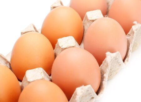 eggs in carton tray isolated on whiteの写真素材