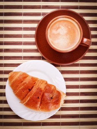 fresh coffee cup and croissant on bamboo napkinの写真素材