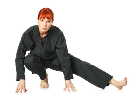 girl in black kimono exercise, isolated on whiteの写真素材