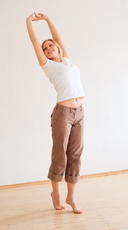 cute young girl walking and stretches at homeの写真素材
