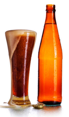 glass full of dark beer and bottle, isolated on whiteの写真素材