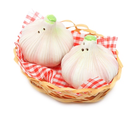 garlic shaped pepper and salt castors isolated on whiteの写真素材