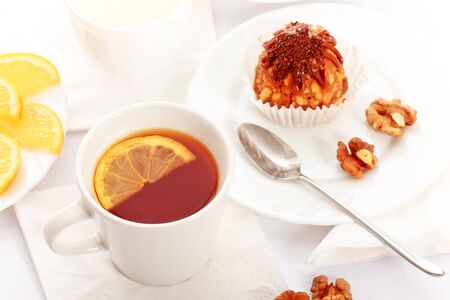 tea with lemon and fancy cakes, still lifeの写真素材