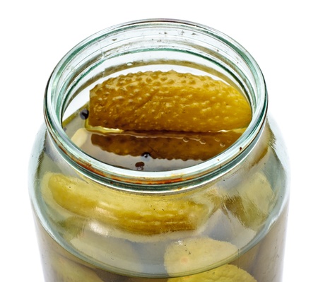 opened glass jar of green pickled cucumbersの写真素材