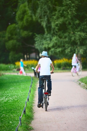 teenager on bicycle in park at summer dayの写真素材