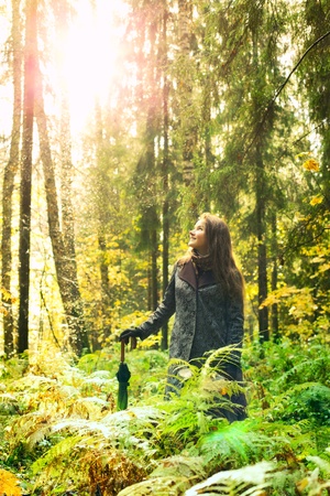 beautiful girl with long hair in autumn rainy forestの写真素材