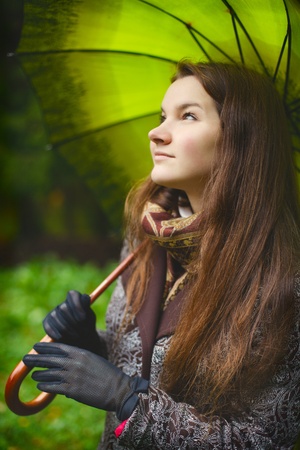 beautiful girl with long hair in autumn rainy forestの写真素材