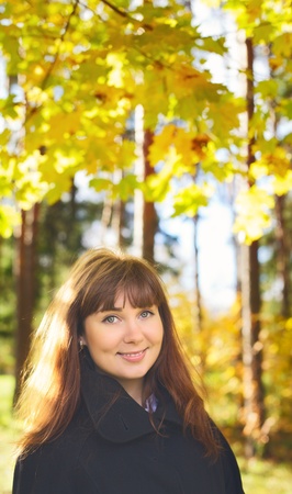beautiful girl with long hair in autumn rainy forestの写真素材