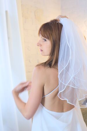 beautiful woman in white wedding dress and bridal veilの写真素材