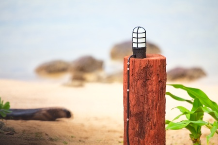lamp in wooden stand on a beachの写真素材