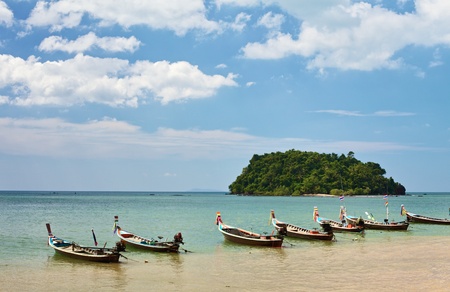 traditional thai long boats on beach in Thailandの写真素材