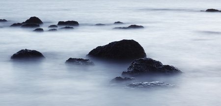 rocks in surf, Andaman Sea, long exposureの写真素材