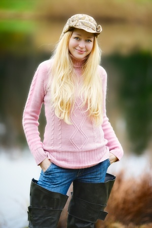beautiful girl with long blond hair and pink jersey fishingの写真素材