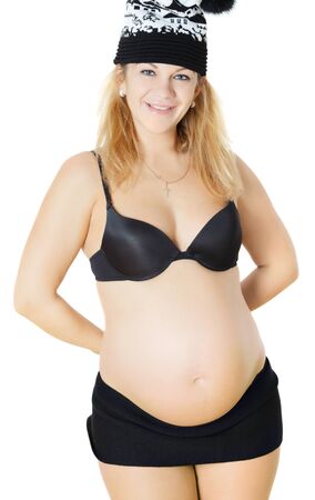 happy young pregnant woman in winter hatの写真素材